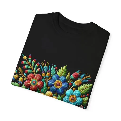 Colorful floral t-shirt with artistic flower print, vibrant unisex garment-dyed tee, bohemian botanical design t-shirt, handmade style floral print tee on light blue fabric.