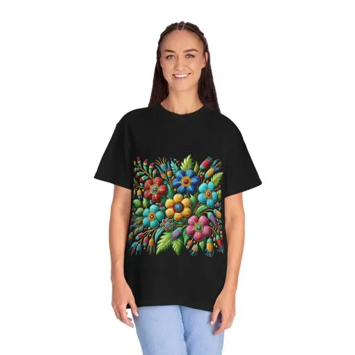 Colorful floral t-shirt with artistic flower print, vibrant unisex garment-dyed tee, bohemian botanical design t-shirt, handmade style floral print tee on light blue fabric.