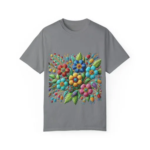 Colorful floral t-shirt with artistic flower print, vibrant unisex garment-dyed tee, bohemian botanical design t-shirt, handmade style floral print tee on light blue fabric.