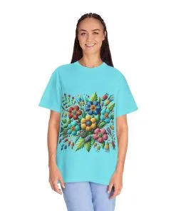 Colorful floral t-shirt with artistic flower print, vibrant unisex garment-dyed tee, bohemian botanical design t-shirt, handmade style floral print tee on light blue fabric.