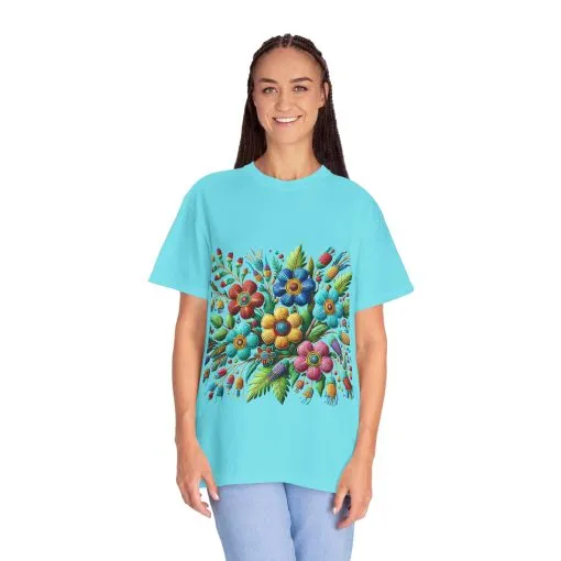 Colorful floral t-shirt with artistic flower print, vibrant unisex garment-dyed tee, bohemian botanical design t-shirt, handmade style floral print tee on light blue fabric.