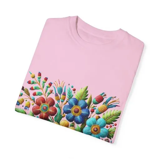 Colorful floral t-shirt with artistic flower print, vibrant unisex garment-dyed tee, bohemian botanical design t-shirt, handmade style floral print tee on light blue fabric.