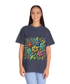 Colorful floral t-shirt with artistic flower print, vibrant unisex garment-dyed tee, bohemian botanical design t-shirt, handmade style floral print tee on light blue fabric.