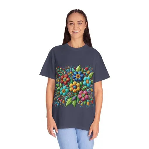 Colorful floral t-shirt with artistic flower print, vibrant unisex garment-dyed tee, bohemian botanical design t-shirt, handmade style floral print tee on light blue fabric.