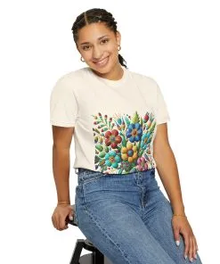 Colorful floral t-shirt with artistic flower print, vibrant unisex garment-dyed tee, bohemian botanical design t-shirt, handmade style floral print tee on light blue fabric.