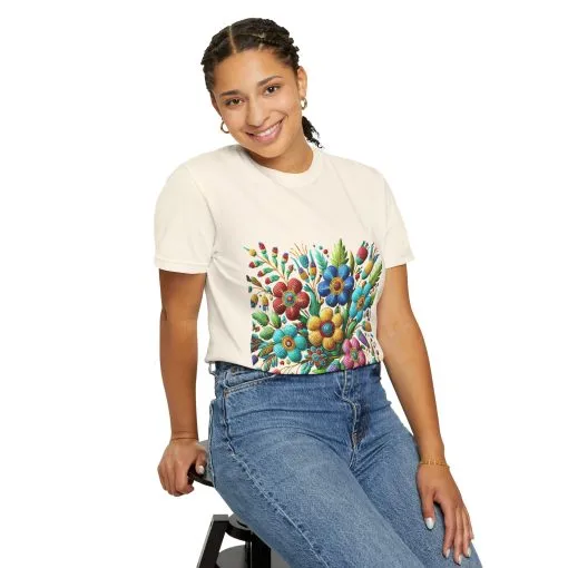 Colorful floral t-shirt with artistic flower print, vibrant unisex garment-dyed tee, bohemian botanical design t-shirt, handmade style floral print tee on light blue fabric.