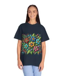 Colorful floral t-shirt with artistic flower print, vibrant unisex garment-dyed tee, bohemian botanical design t-shirt, handmade style floral print tee on light blue fabric.