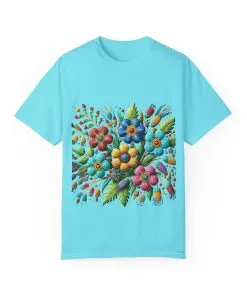 Colorful floral t-shirt with artistic flower print, vibrant unisex garment-dyed tee, bohemian botanical design t-shirt, handmade style floral print tee on light blue fabric.