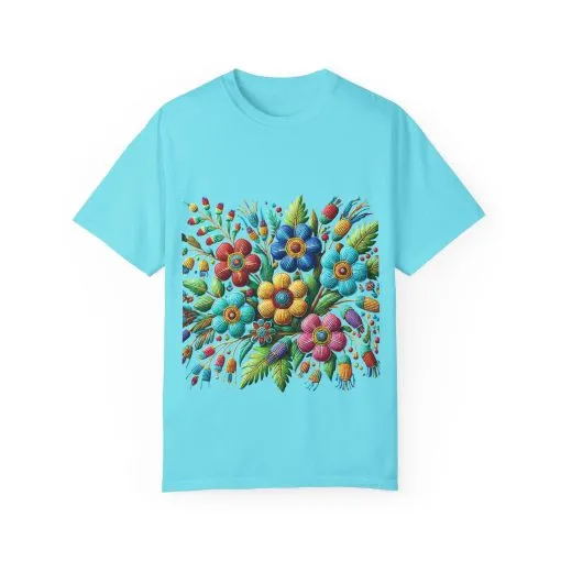 Colorful floral t-shirt with artistic flower print, vibrant unisex garment-dyed tee, bohemian botanical design t-shirt, handmade style floral print tee on light blue fabric.