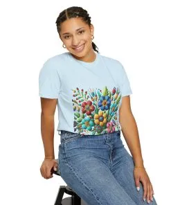 Colorful floral t-shirt with artistic flower print, vibrant unisex garment-dyed tee, bohemian botanical design t-shirt, handmade style floral print tee on light blue fabric.