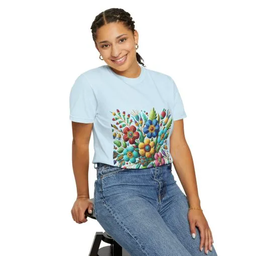 Colorful floral t-shirt with artistic flower print, vibrant unisex garment-dyed tee, bohemian botanical design t-shirt, handmade style floral print tee on light blue fabric.
