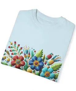 Colorful floral t-shirt with artistic flower print, vibrant unisex garment-dyed tee, bohemian botanical design t-shirt, handmade style floral print tee on light blue fabric.