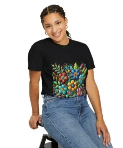Colorful floral t-shirt with artistic flower print, vibrant unisex garment-dyed tee, bohemian botanical design t-shirt, handmade style floral print tee on light blue fabric.