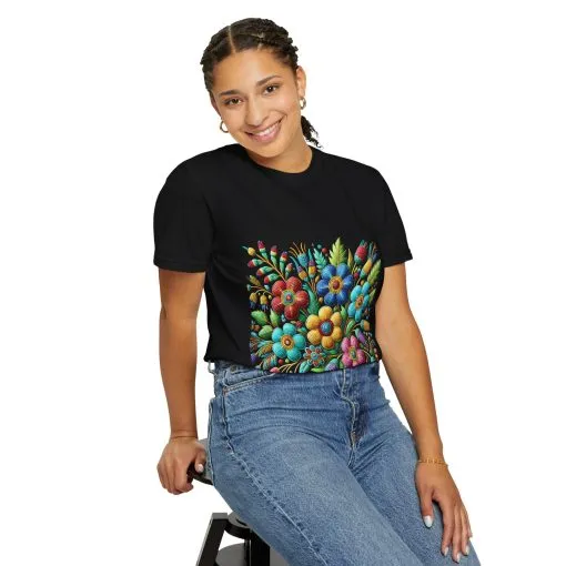 Colorful floral t-shirt with artistic flower print, vibrant unisex garment-dyed tee, bohemian botanical design t-shirt, handmade style floral print tee on light blue fabric.