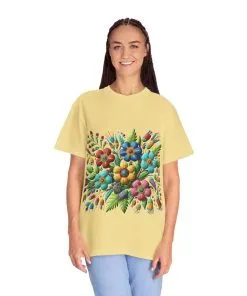 Colorful floral t-shirt with artistic flower print, vibrant unisex garment-dyed tee, bohemian botanical design t-shirt, handmade style floral print tee on light blue fabric.