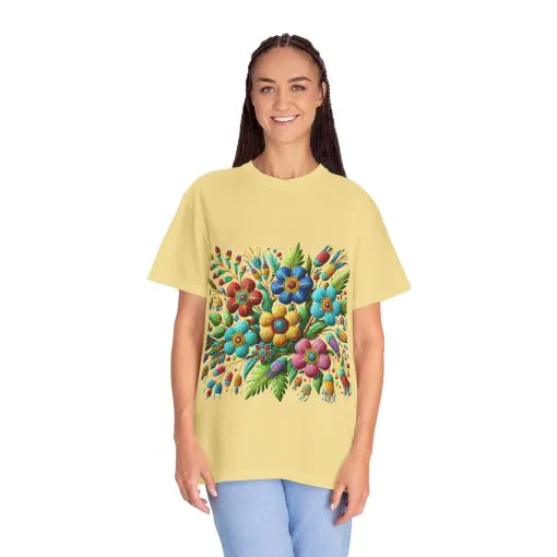 Colorful floral t-shirt with artistic flower print, vibrant unisex garment-dyed tee, bohemian botanical design t-shirt, handmade style floral print tee on light blue fabric.