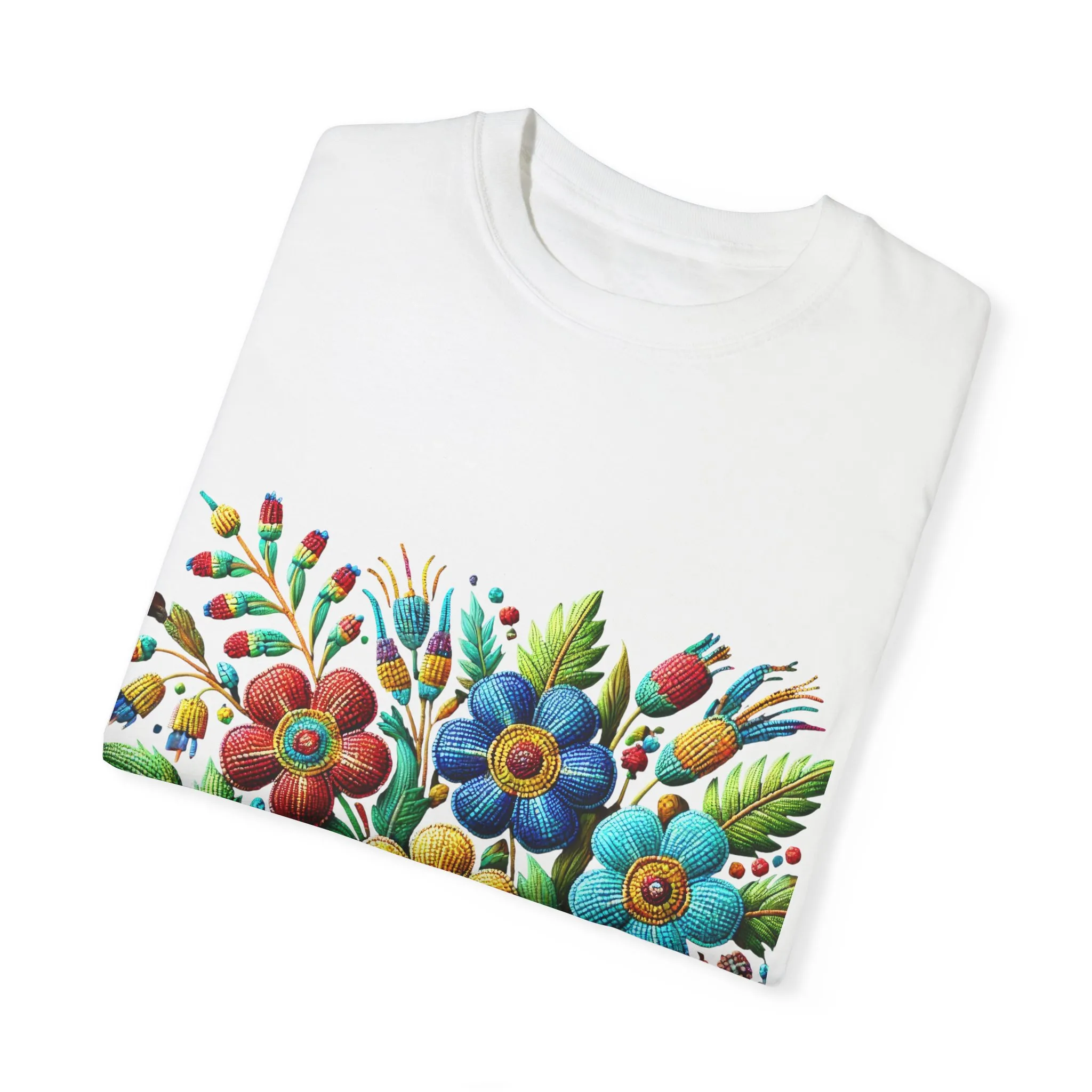 Colorful floral t-shirt with artistic flower print, vibrant unisex garment-dyed tee, bohemian botanical design t-shirt, handmade style floral print tee on light blue fabric.