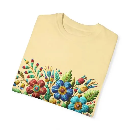Colorful floral t-shirt with artistic flower print, vibrant unisex garment-dyed tee, bohemian botanical design t-shirt, handmade style floral print tee on light blue fabric.