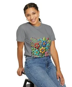 Colorful floral t-shirt with artistic flower print, vibrant unisex garment-dyed tee, bohemian botanical design t-shirt, handmade style floral print tee on light blue fabric.