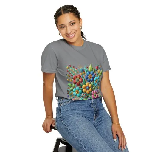 Colorful floral t-shirt with artistic flower print, vibrant unisex garment-dyed tee, bohemian botanical design t-shirt, handmade style floral print tee on light blue fabric.