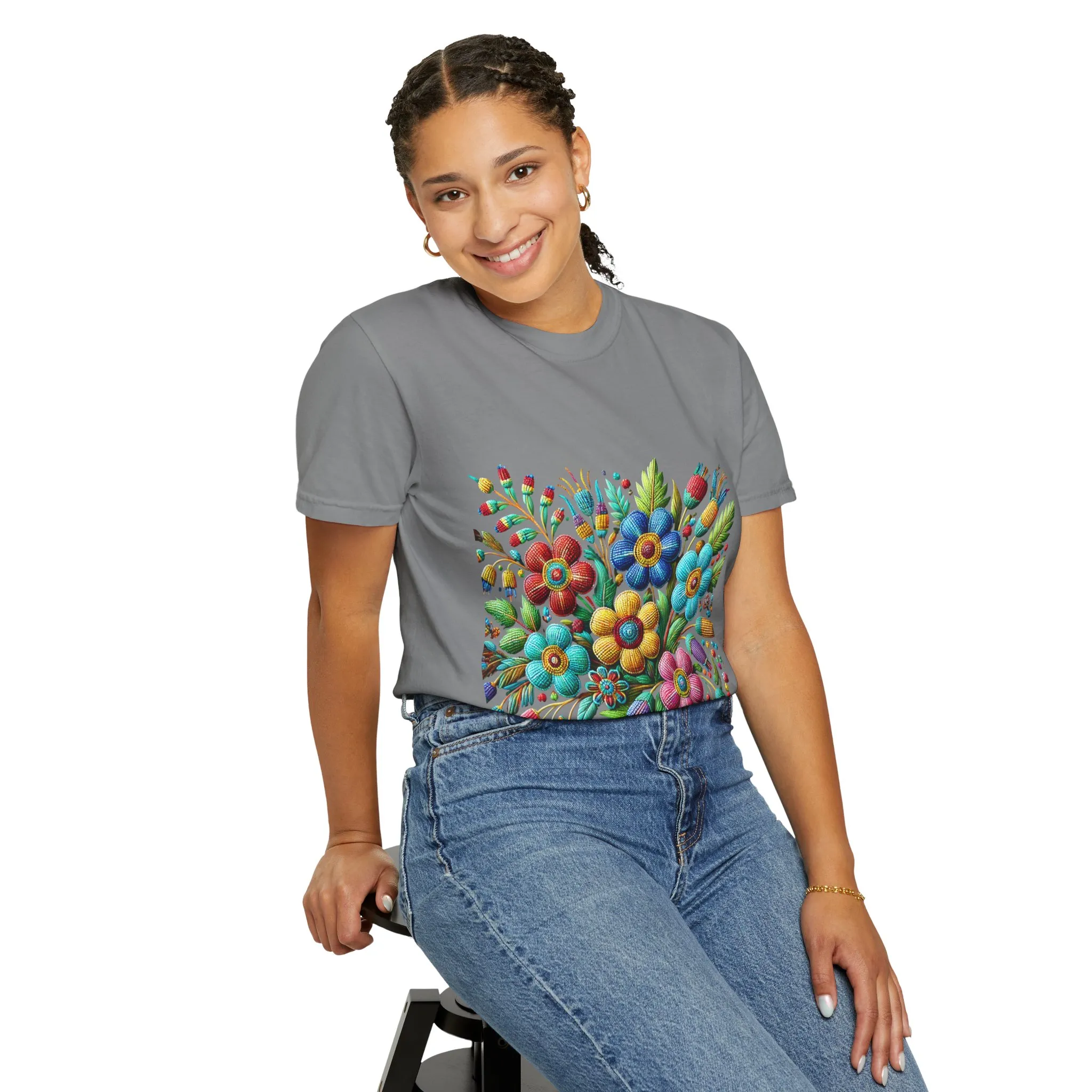 Colorful floral t-shirt with artistic flower print, vibrant unisex garment-dyed tee, bohemian botanical design t-shirt, handmade style floral print tee on light blue fabric.