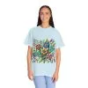 Colorful floral t-shirt with artistic flower print, vibrant unisex garment-dyed tee, bohemian botanical design t-shirt, handmade style floral print tee on light blue fabric.