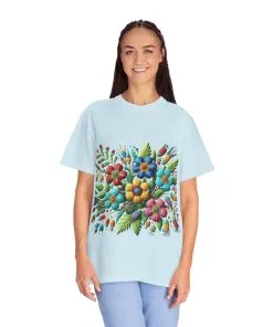 Colorful floral t-shirt with artistic flower print, vibrant unisex garment-dyed tee, bohemian botanical design t-shirt, handmade style floral print tee on light blue fabric.