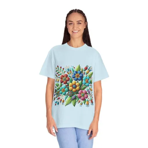 Colorful floral t-shirt with artistic flower print, vibrant unisex garment-dyed tee, bohemian botanical design t-shirt, handmade style floral print tee on light blue fabric.