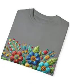 Colorful floral t-shirt with artistic flower print, vibrant unisex garment-dyed tee, bohemian botanical design t-shirt, handmade style floral print tee on light blue fabric.