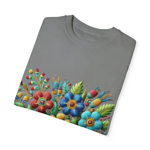Colorful floral t-shirt with artistic flower print, vibrant unisex garment-dyed tee, bohemian botanical design t-shirt, handmade style floral print tee on light blue fabric.