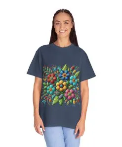 Colorful floral t-shirt with artistic flower print, vibrant unisex garment-dyed tee, bohemian botanical design t-shirt, handmade style floral print tee on light blue fabric.