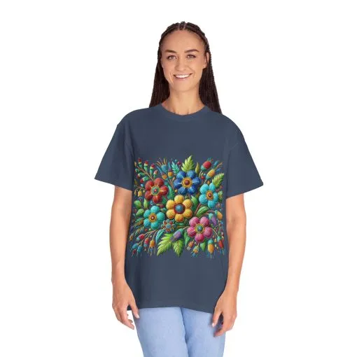 Colorful floral t-shirt with artistic flower print, vibrant unisex garment-dyed tee, bohemian botanical design t-shirt, handmade style floral print tee on light blue fabric.
