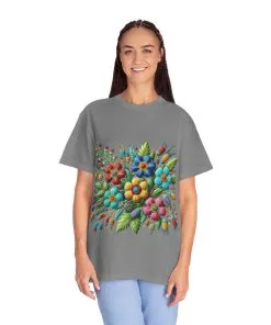 Colorful floral t-shirt with artistic flower print, vibrant unisex garment-dyed tee, bohemian botanical design t-shirt, handmade style floral print tee on light blue fabric.