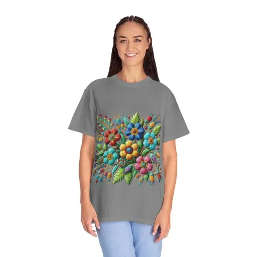 Colorful floral t-shirt with artistic flower print, vibrant unisex garment-dyed tee, bohemian botanical design t-shirt, handmade style floral print tee on light blue fabric.