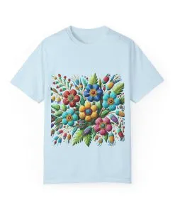 Colorful floral t-shirt with artistic flower print, vibrant unisex garment-dyed tee, bohemian botanical design t-shirt, handmade style floral print tee on light blue fabric.