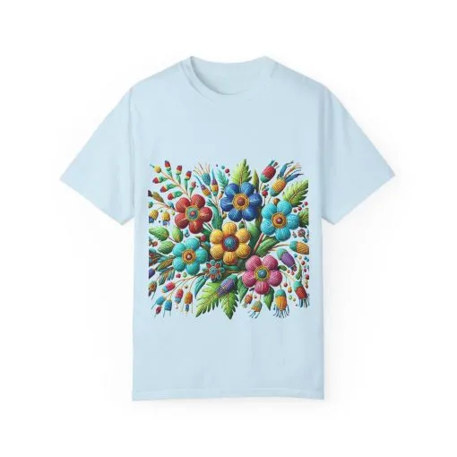 Colorful floral t-shirt with artistic flower print, vibrant unisex garment-dyed tee, bohemian botanical design t-shirt, handmade style floral print tee on light blue fabric.
