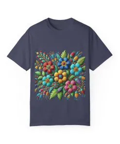 Colorful floral t-shirt with artistic flower print, vibrant unisex garment-dyed tee, bohemian botanical design t-shirt, handmade style floral print tee on light blue fabric.