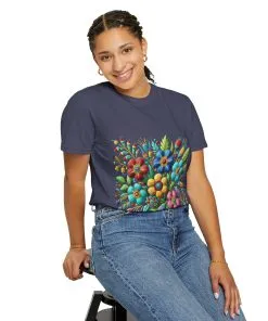 Colorful floral t-shirt with artistic flower print, vibrant unisex garment-dyed tee, bohemian botanical design t-shirt, handmade style floral print tee on light blue fabric.