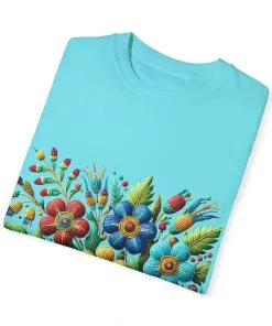 Colorful floral t-shirt with artistic flower print, vibrant unisex garment-dyed tee, bohemian botanical design t-shirt, handmade style floral print tee on light blue fabric.