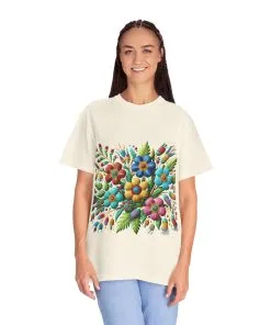 Colorful floral t-shirt with artistic flower print, vibrant unisex garment-dyed tee, bohemian botanical design t-shirt, handmade style floral print tee on light blue fabric.