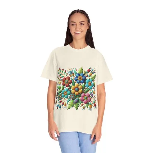 Colorful floral t-shirt with artistic flower print, vibrant unisex garment-dyed tee, bohemian botanical design t-shirt, handmade style floral print tee on light blue fabric.