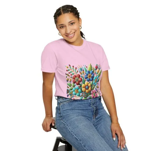 Colorful floral t-shirt with artistic flower print, vibrant unisex garment-dyed tee, bohemian botanical design t-shirt, handmade style floral print tee on light blue fabric.